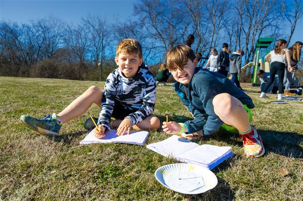 boys sitting in the grass